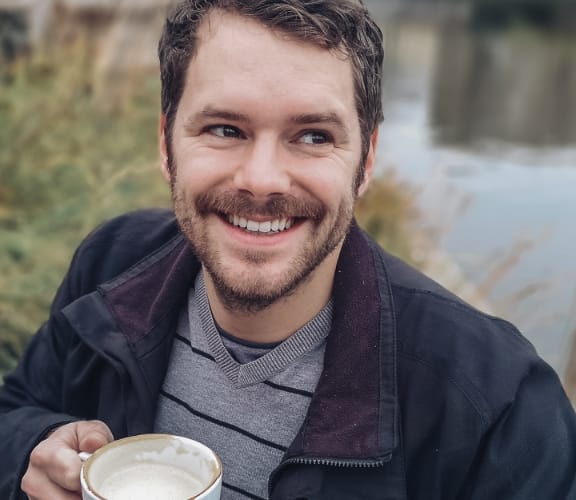 Man sitting down having coffee